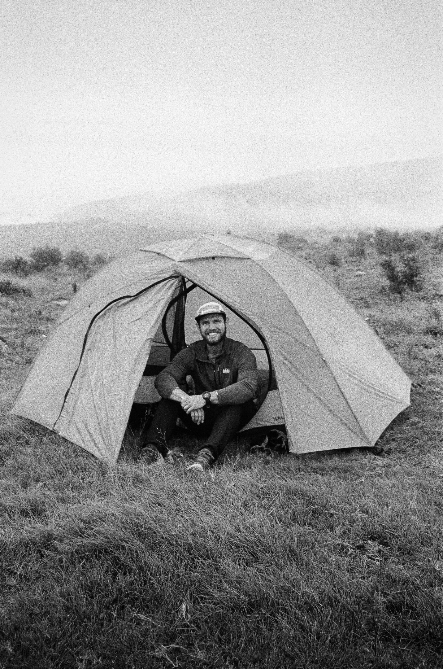 35mm film Nate Bowery sitting in tent while backpacking at Grayson Highlands State Park in Virgina
