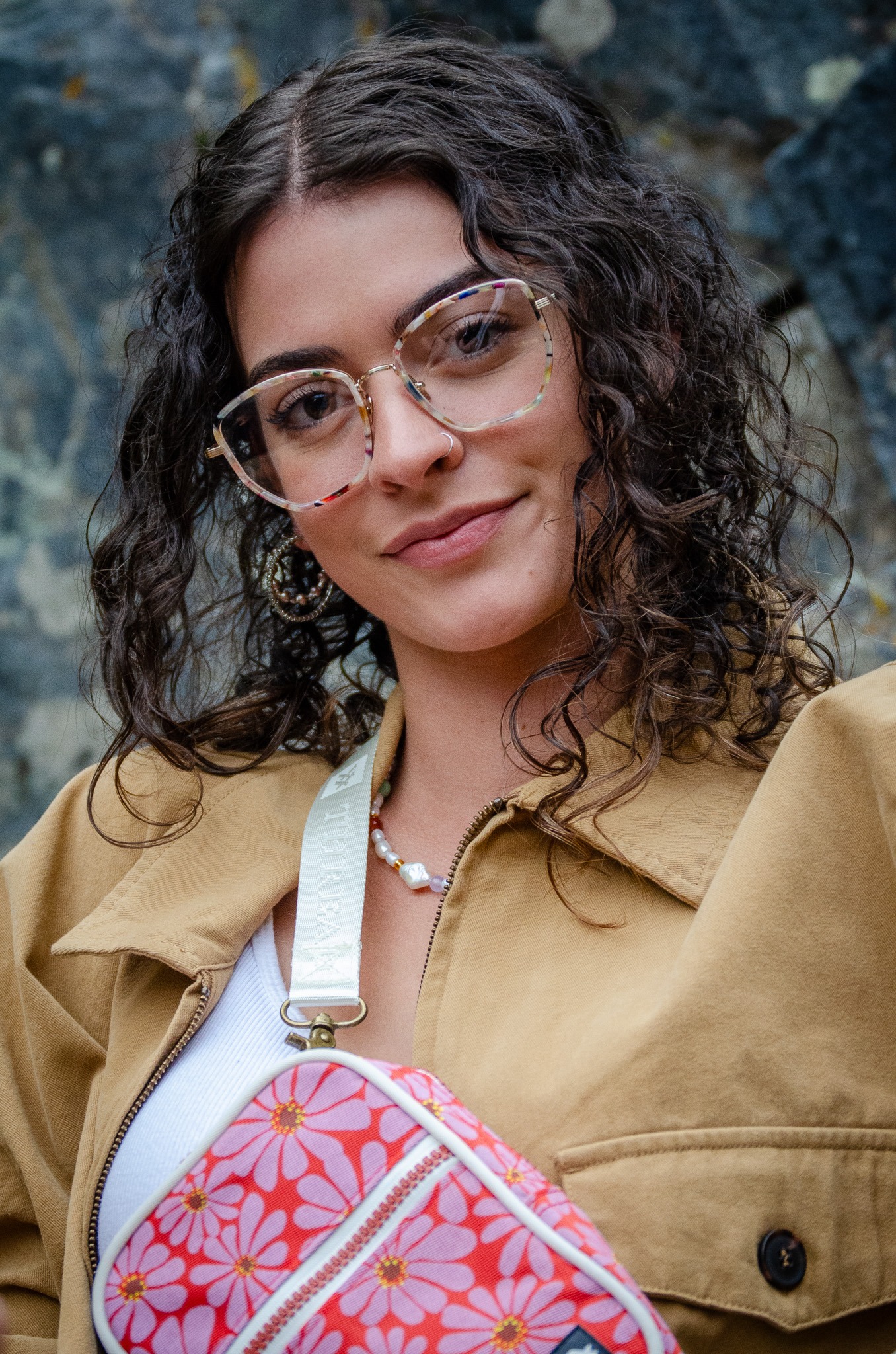 Woman wearing fashionable eyeglass frames, smiling