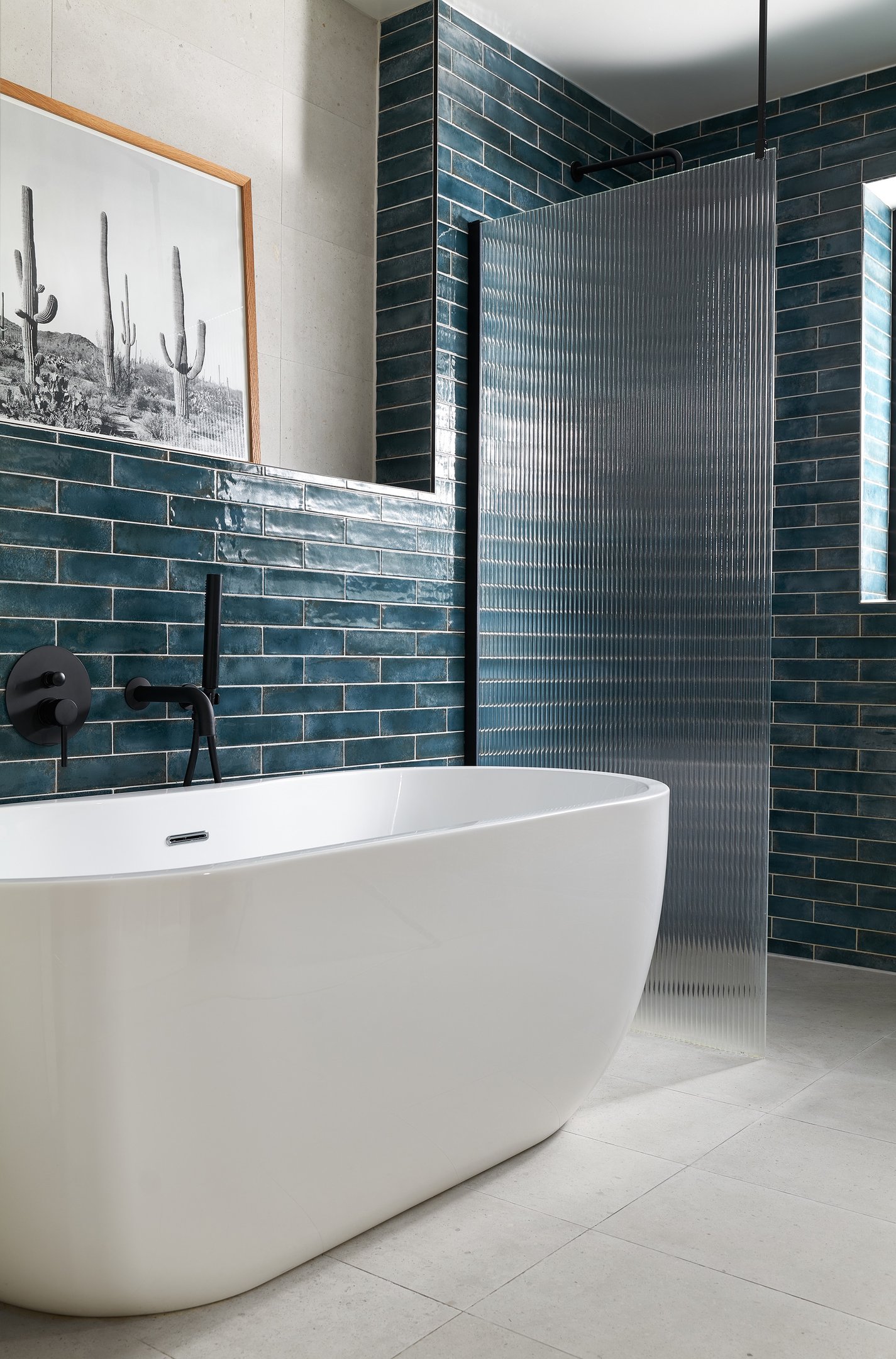 deep, glossy teal metro tiles, laid in a horizontal stack with white grout and fluted shower screen