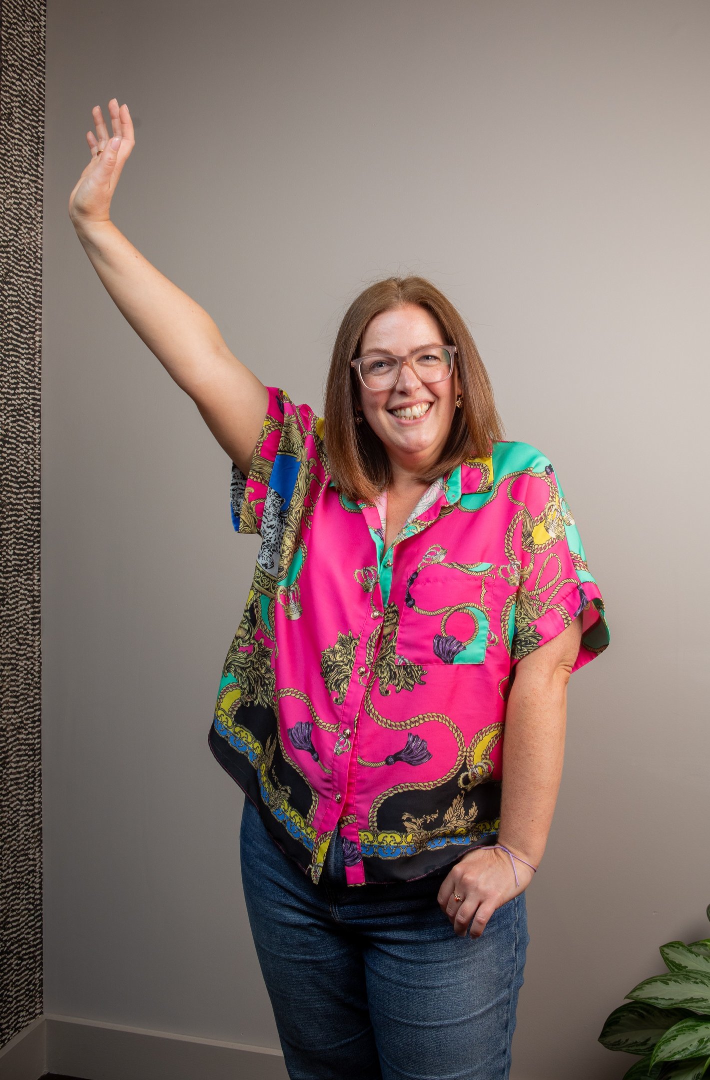 photo of gabi founder of the leopard mind smiling with arm in the air 