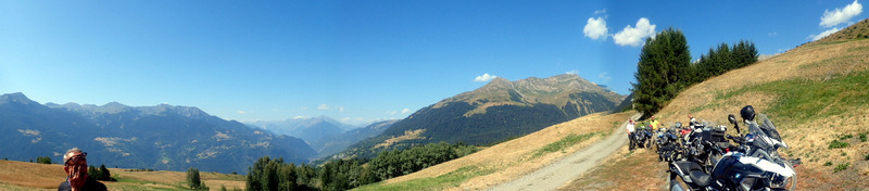 a person standing on a dirt road with a motorcycle