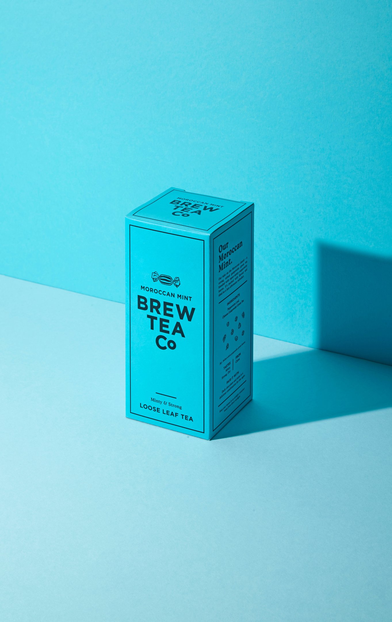 graphic Moody product photography of Brew Tea Co Moroccan Mint loose leaf tea box illuminated in coo