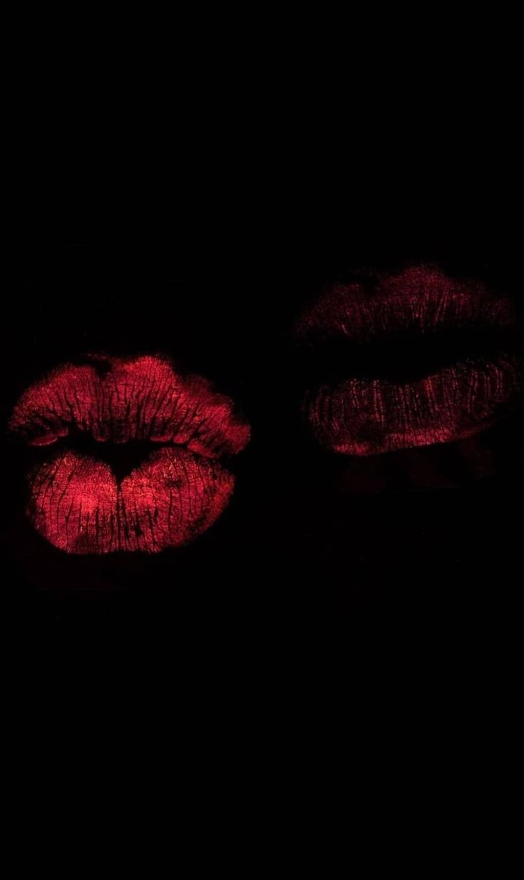 two lips on a black background with red lipstick