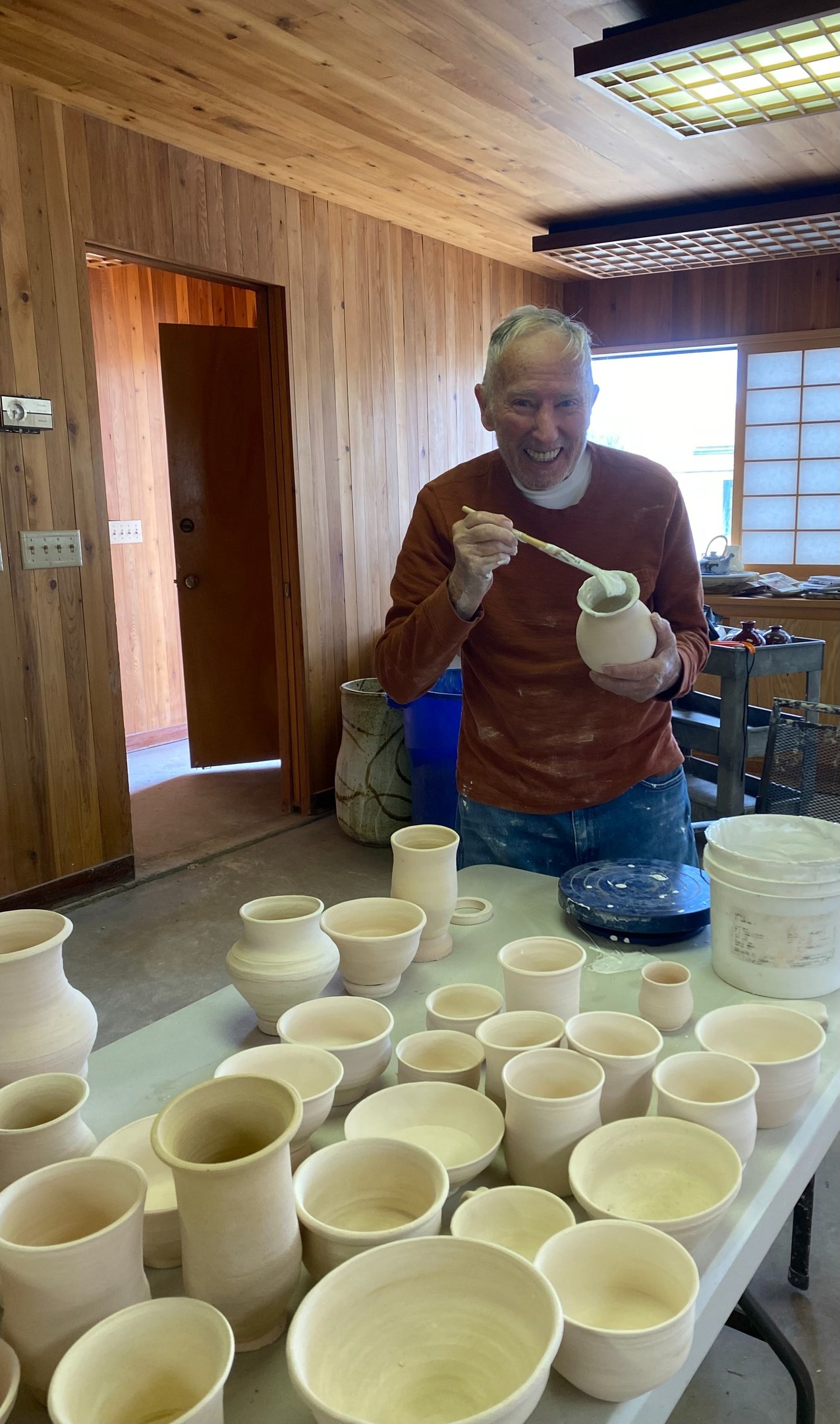 Rich Sim glazing his vase in an art therapy workshop