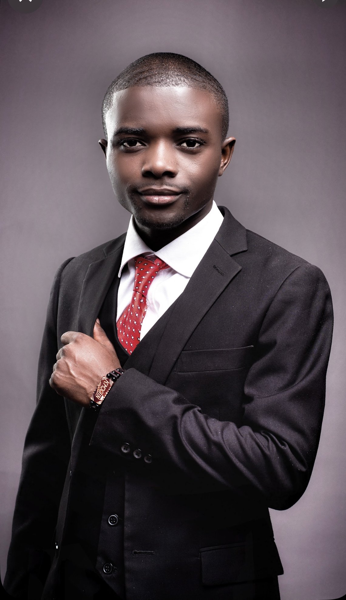 a man in a suit and tie with a red tie