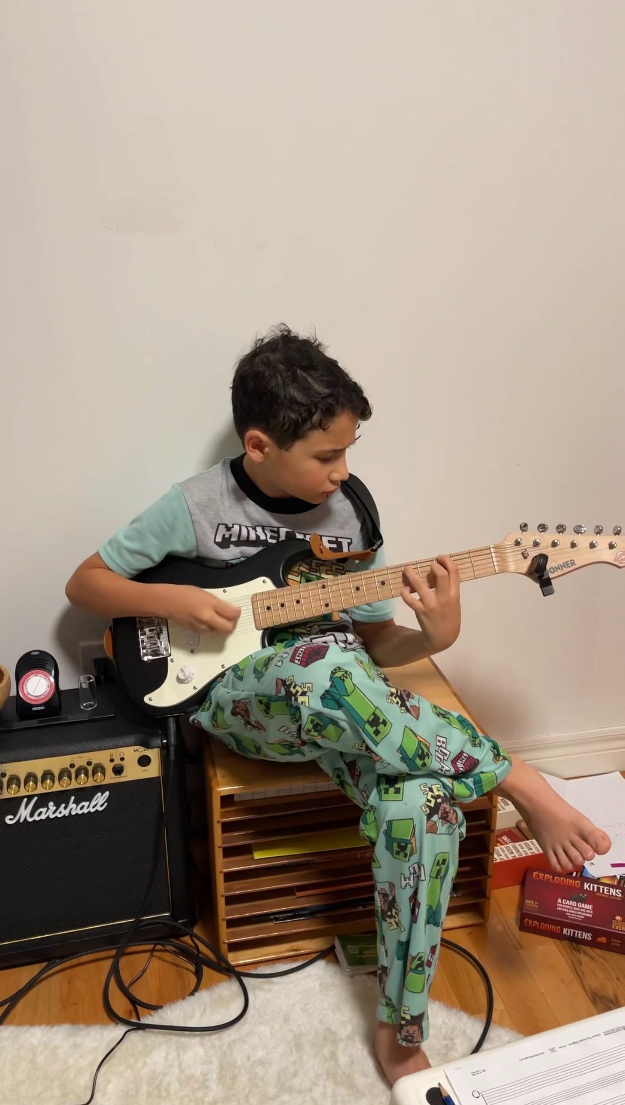 Boy playing guitar in his room