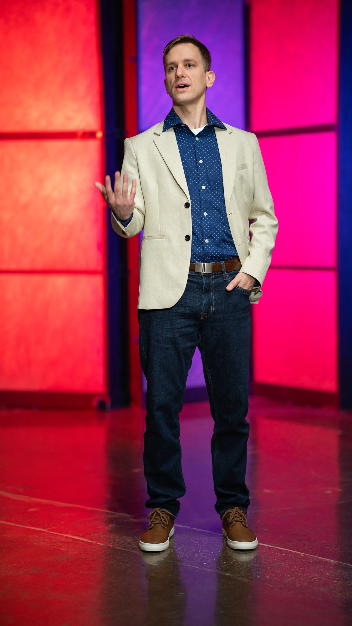 Remy stands on stage speaking