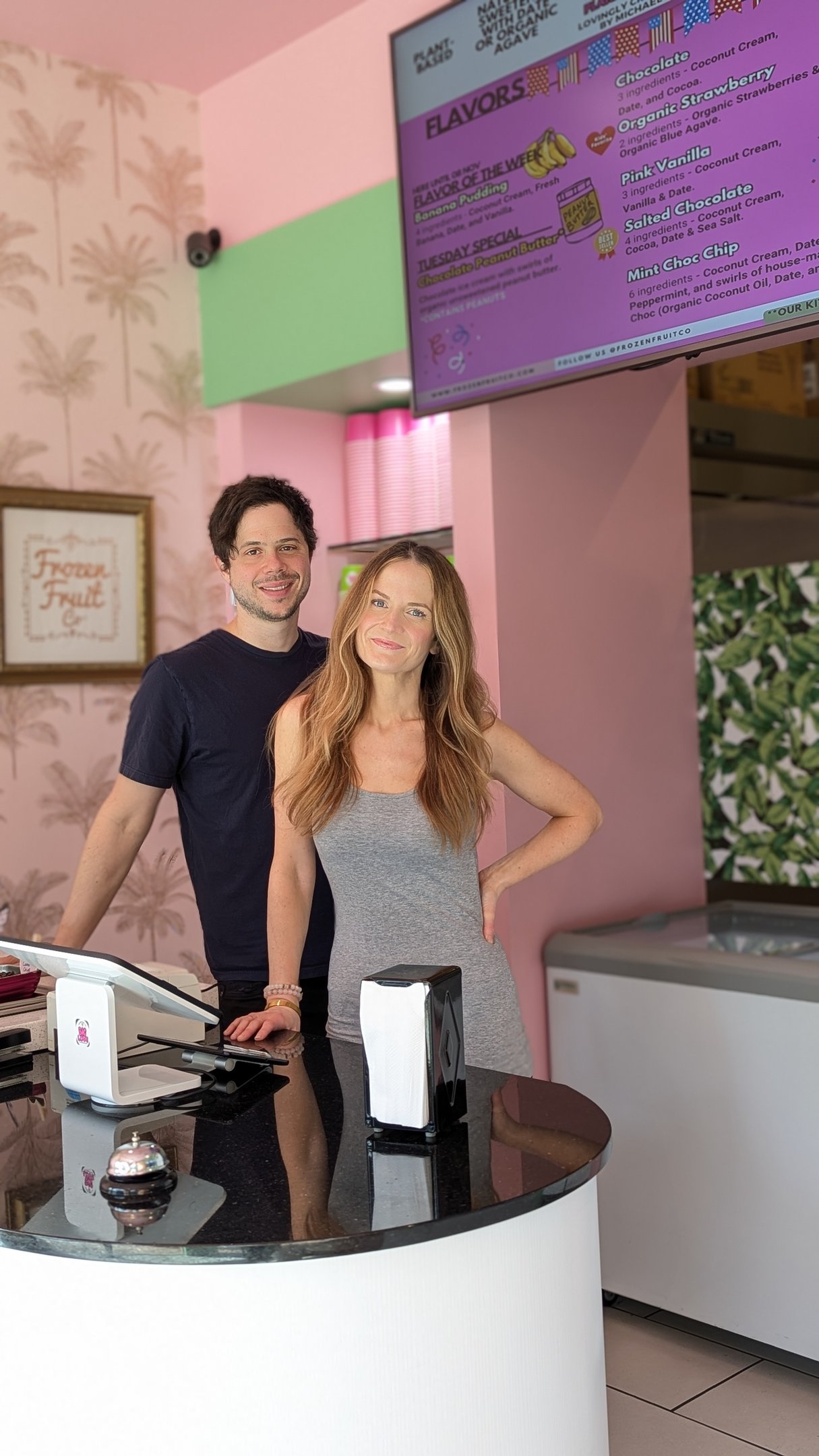 a man and woman standing in front of a counter