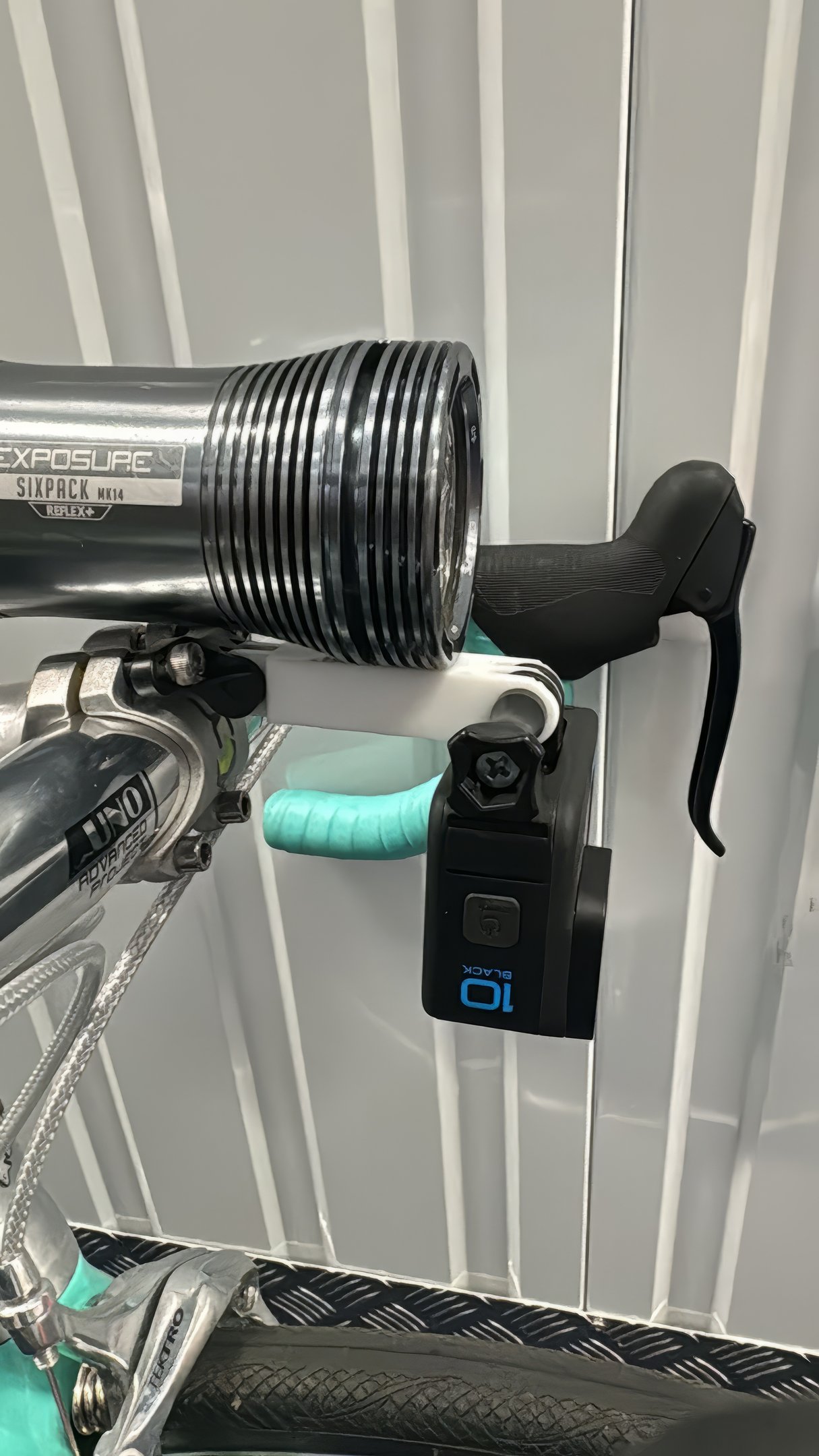 combo mount on a green bike with exposure light and Gopro camera installed