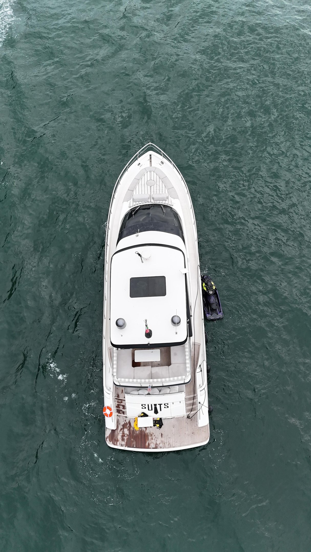 a boat with a man standing on the water