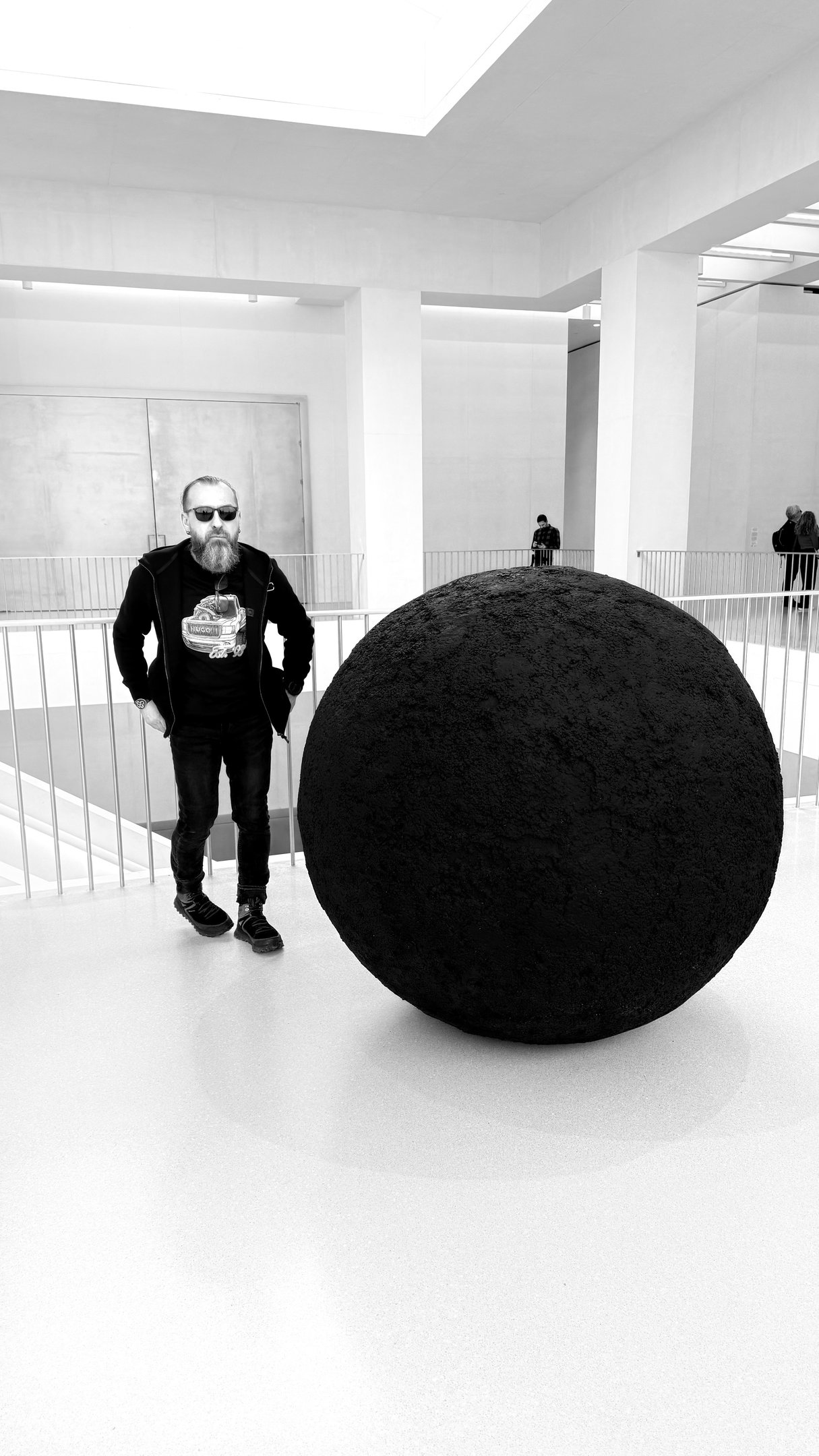JEWELLER standing in front of a large black object