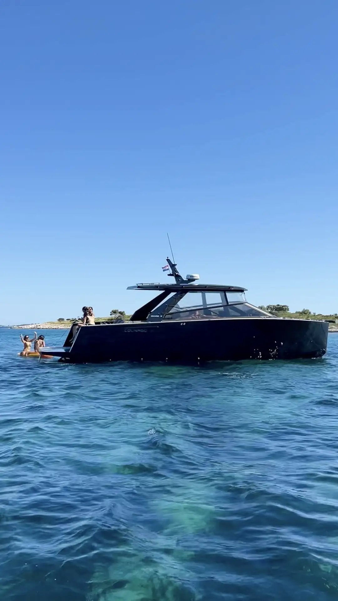 Colnago 35 motor yacht with guests at the Blue Lagoon with guests relaxing on board during a private boat tour from Split