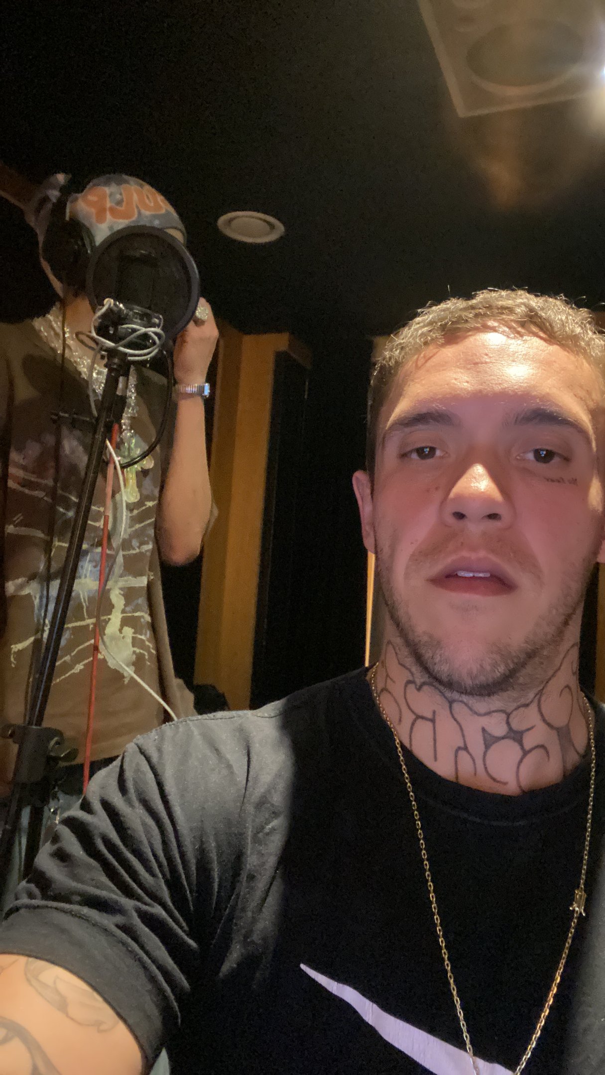 a man with tattoos on his neck and neck