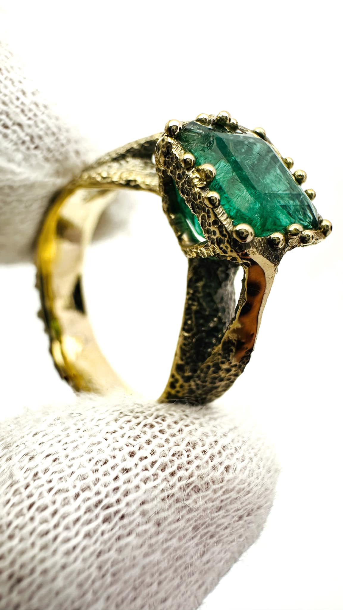 a ring with a green EMERALD stone