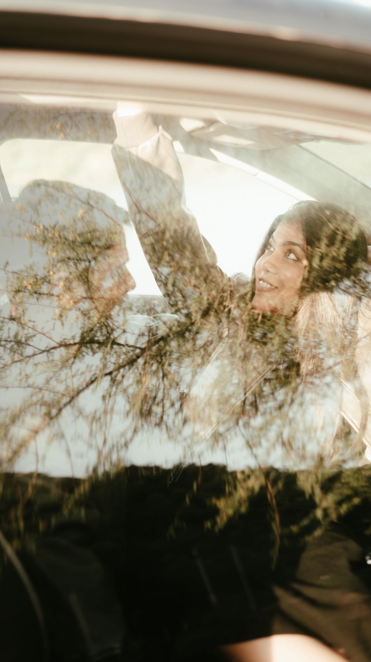 a woman in a car looking happy