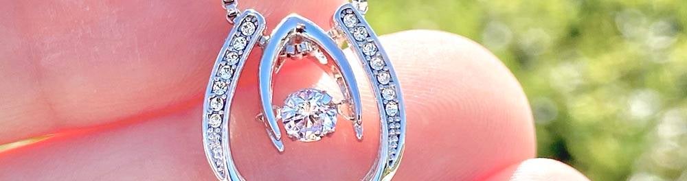 a person holding a diamond necklace with a diamond