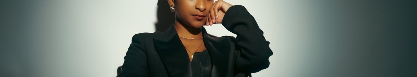 a woman in a black suit and a black jacket