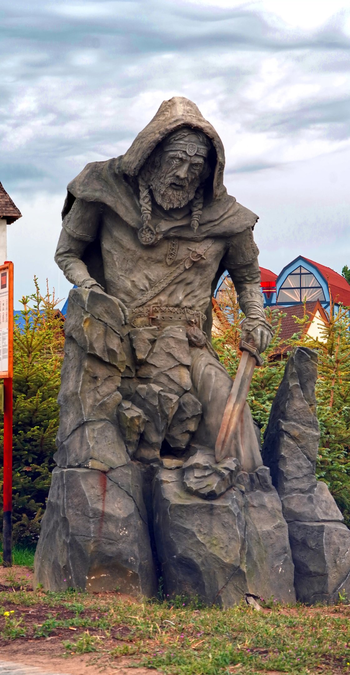 Monumental Viking guardian sculpture with smoke effects beside a Viking roller coaster. 