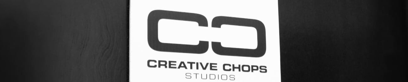 Creative Chops Studios logo on a dark wooden office door