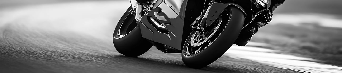 A view of motorcycle wheels as they take a left hand corner