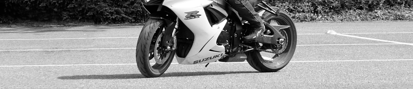 A suzuki GSXR in a car park riding slowly