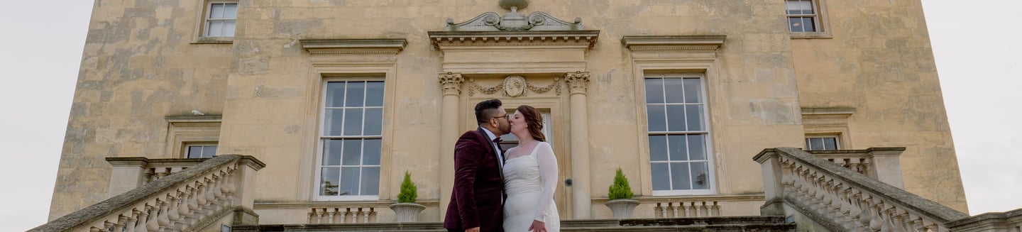 Couple kissing in front of a registry