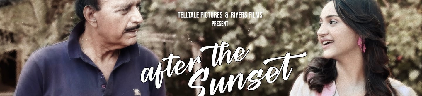 a man and woman standing in front of a tree