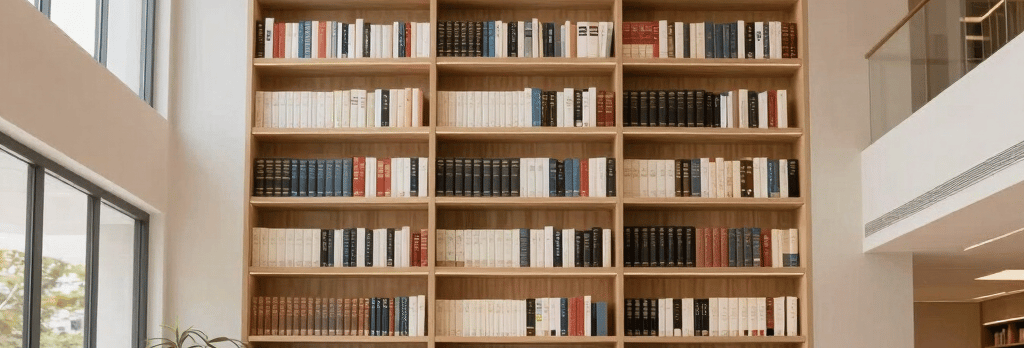 A cozy workspace with pastel-colored books and a laptop displaying an ebook store interface.