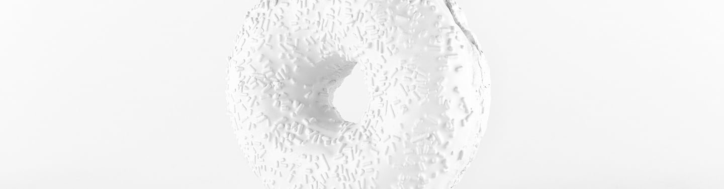 a white sculpture of a large white donut