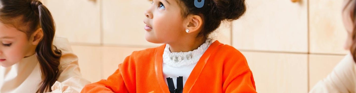 Little girl looking at teacher. Teaching careers in brief
