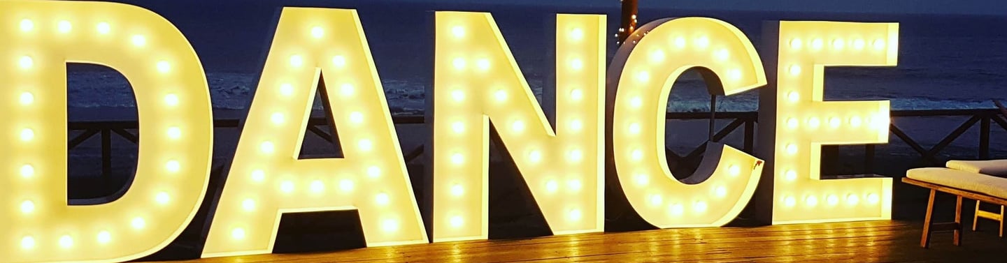 a large light up sign that says dance