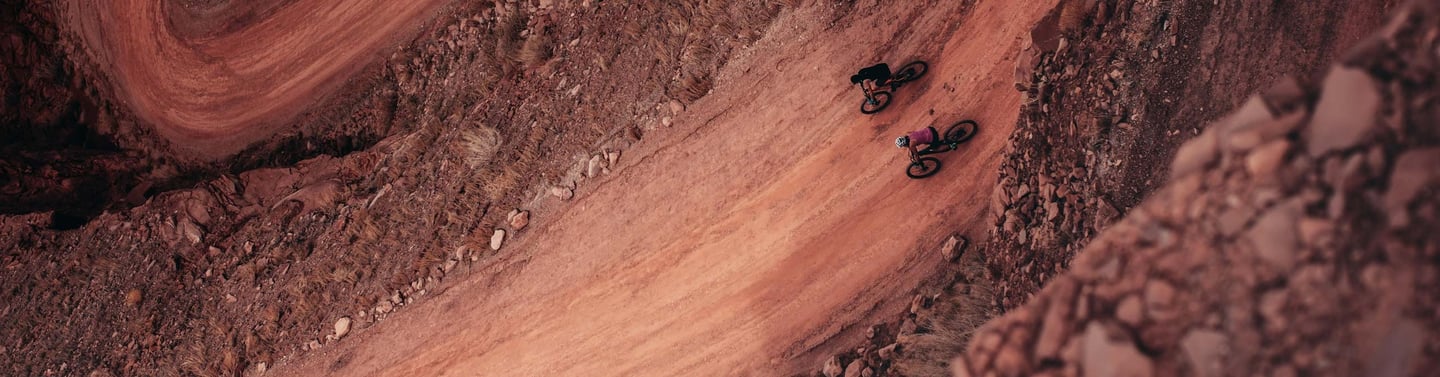 a person riding a bike on a dirt road