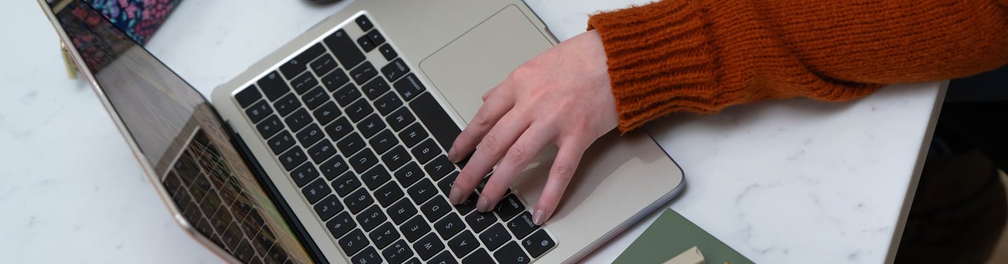 Wirral Brand designer working on brand identity project using MacBook