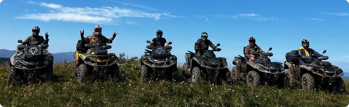 a group of people riding on four wheelers