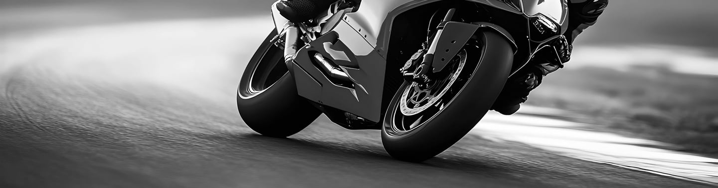 A view of motorcycle wheels as they take a left hand corner