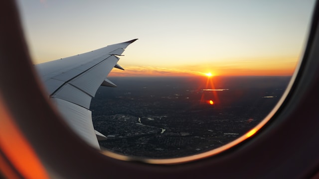 a view of a sunset from a plane, must-need travel accessories