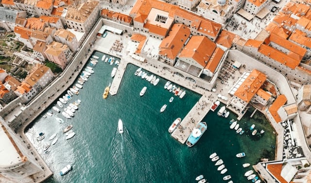 a cityscape of boats in the water, island hopping in Croatia