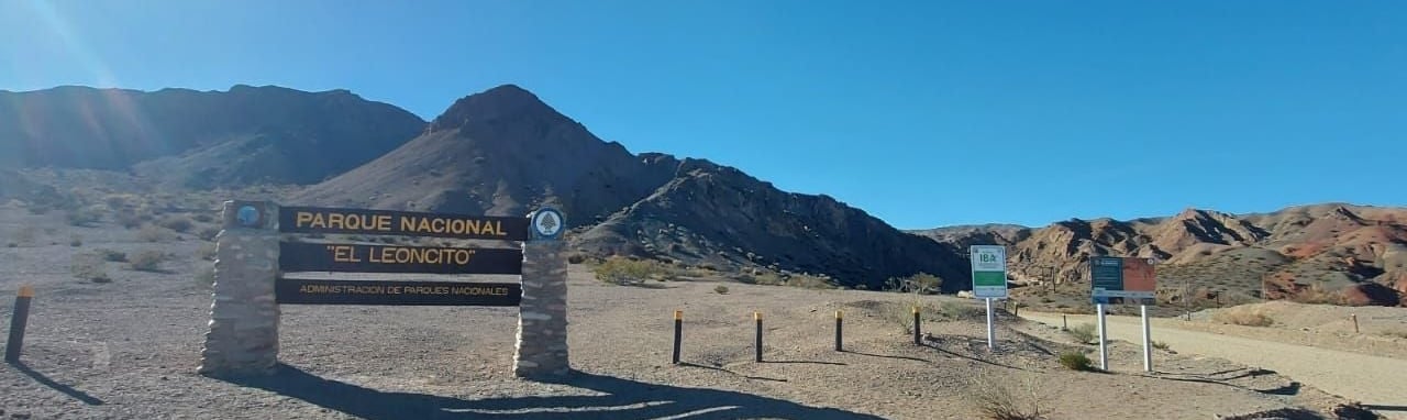 a sign that says private parking lot in front of a mountain