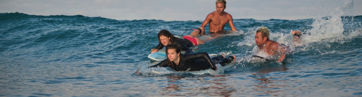 Students enjoying surfing in lombok