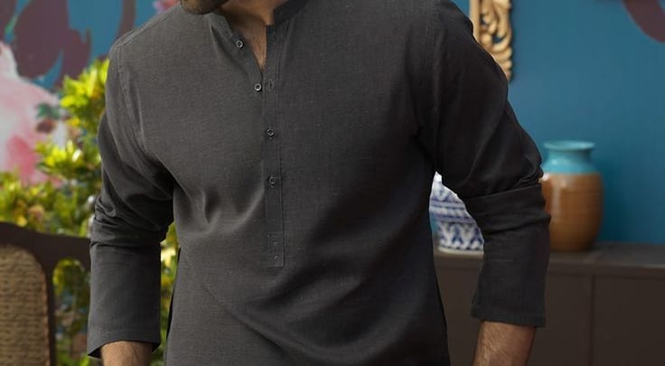 a man in a gray shirt and sunglasses