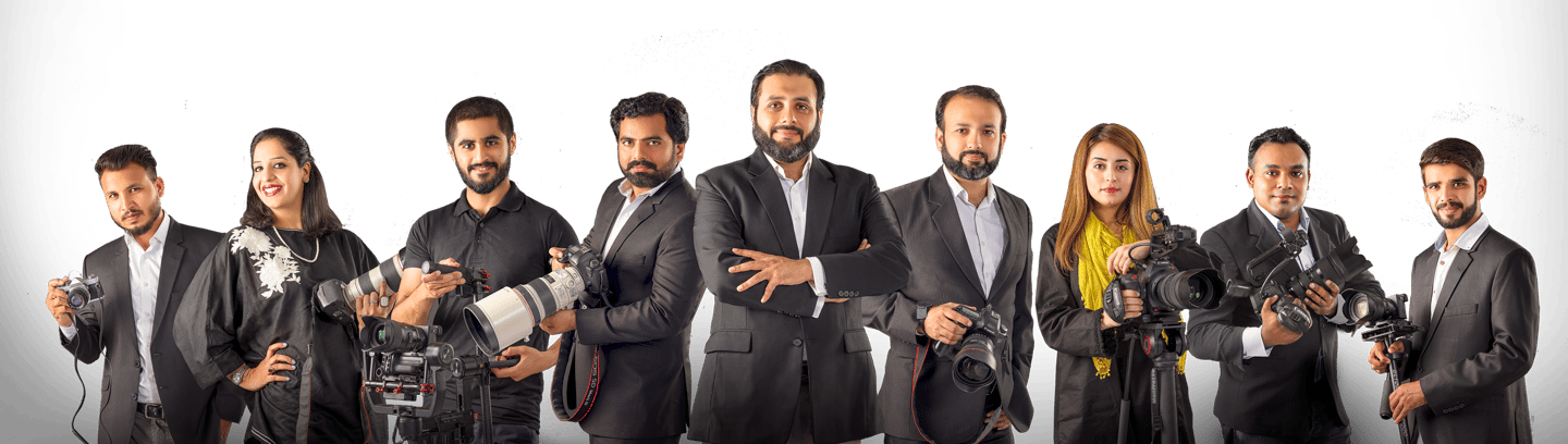 a group of people standing around a camera