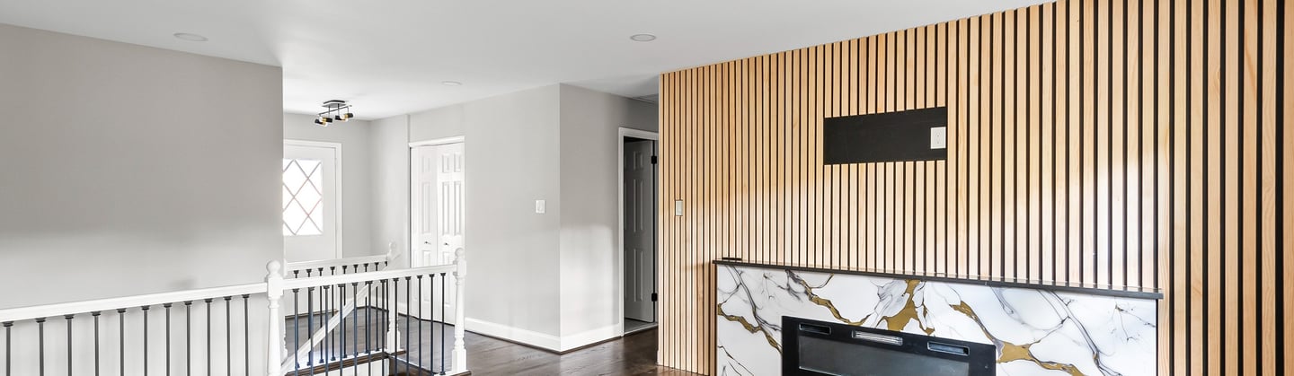 Full home renovation with open living area and modern fireplace by The Great House in Northern Virgi