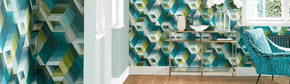 Modern living room featuring geometric teal and green patterned wallpaper with a gold console table.
