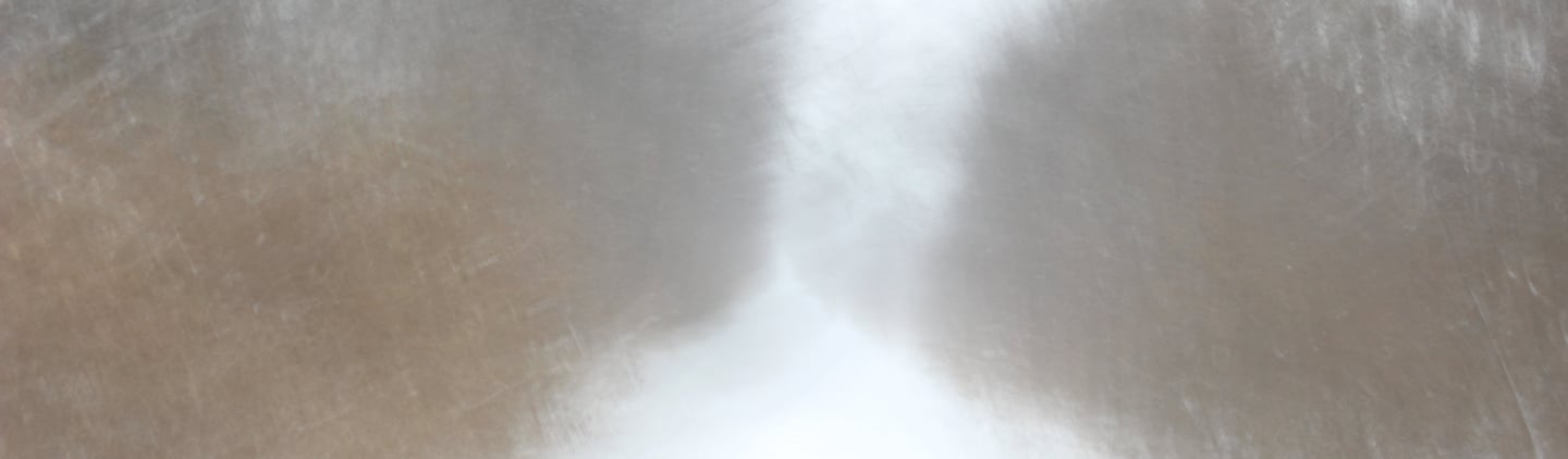 a person walking down a snowy road with a red umbrella