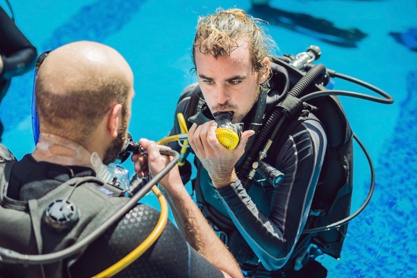 a man in a scuba suit is getting ready to go scuba