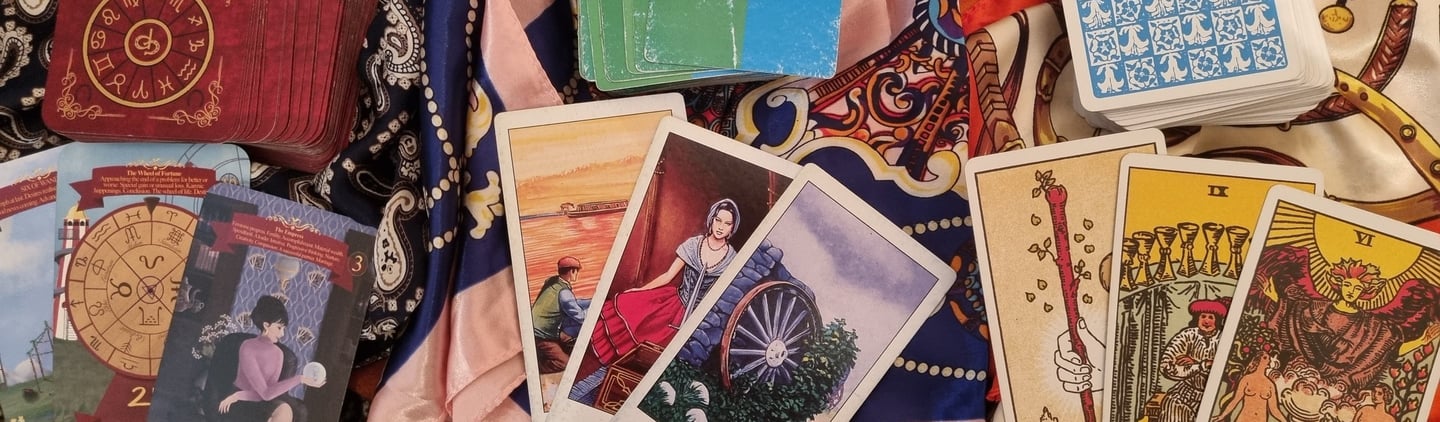 picture of 3 sets of tarot cards front and back
