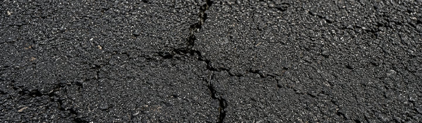 Cracked Asphalt Surface - Early Signs of Pavement Deterioration - Albany Sealcoating & Line Striping, LLC