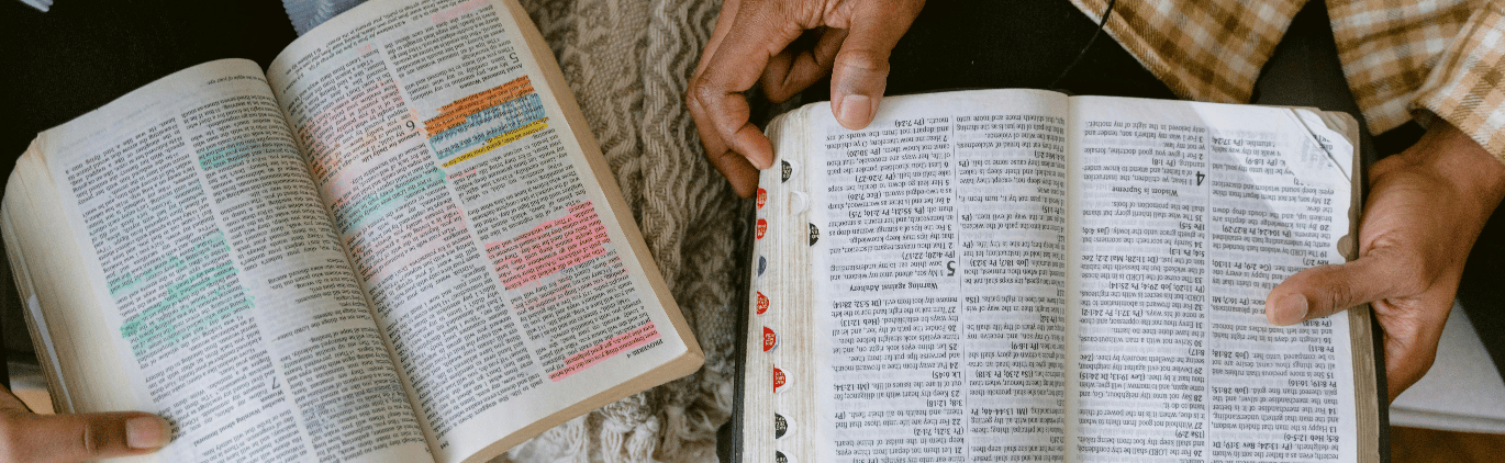 two people sitting on a couch and one is holding a bible