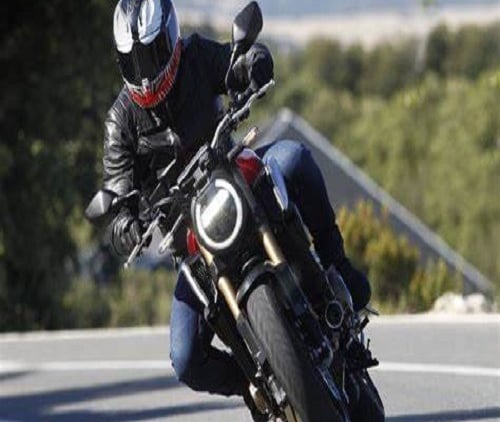 a man riding a motorcycle on a road