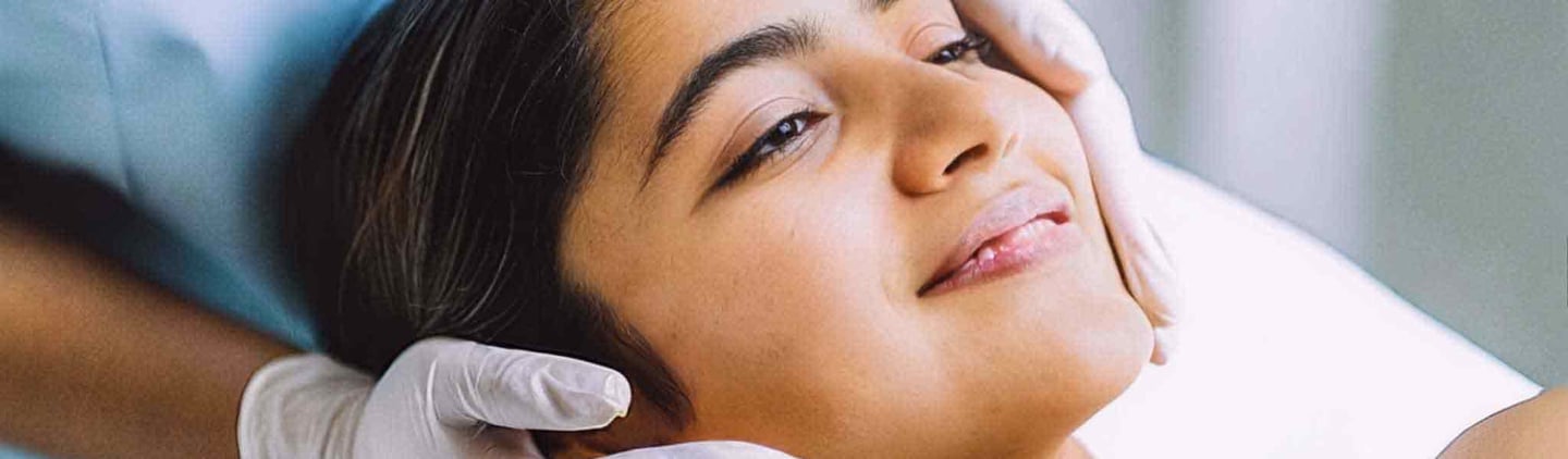 a woman getting a facial lift from a beautician